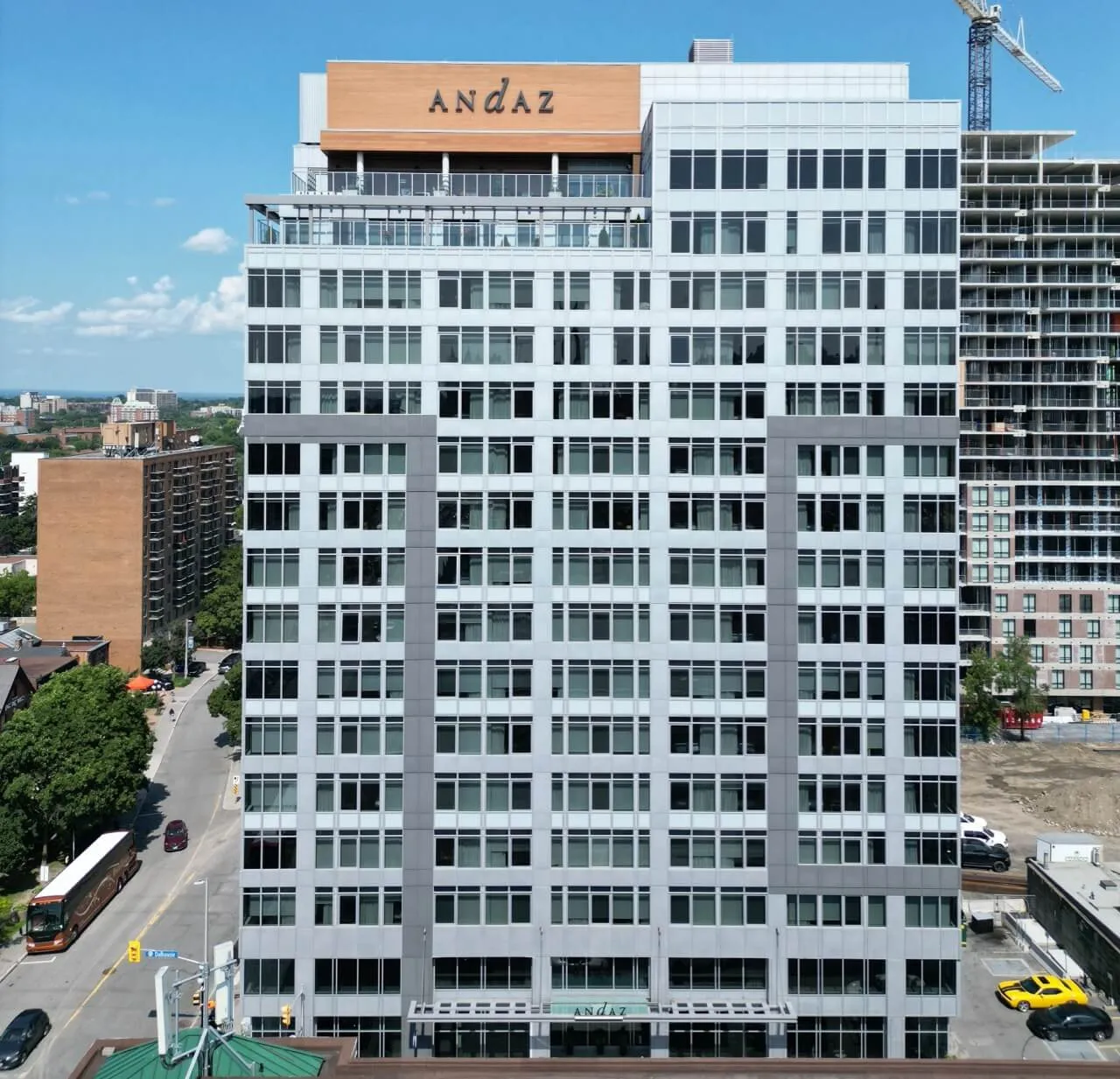 Andaz Ottawa hotel exterior, modern mid-rise building with white and grey facade and rooftop signage.