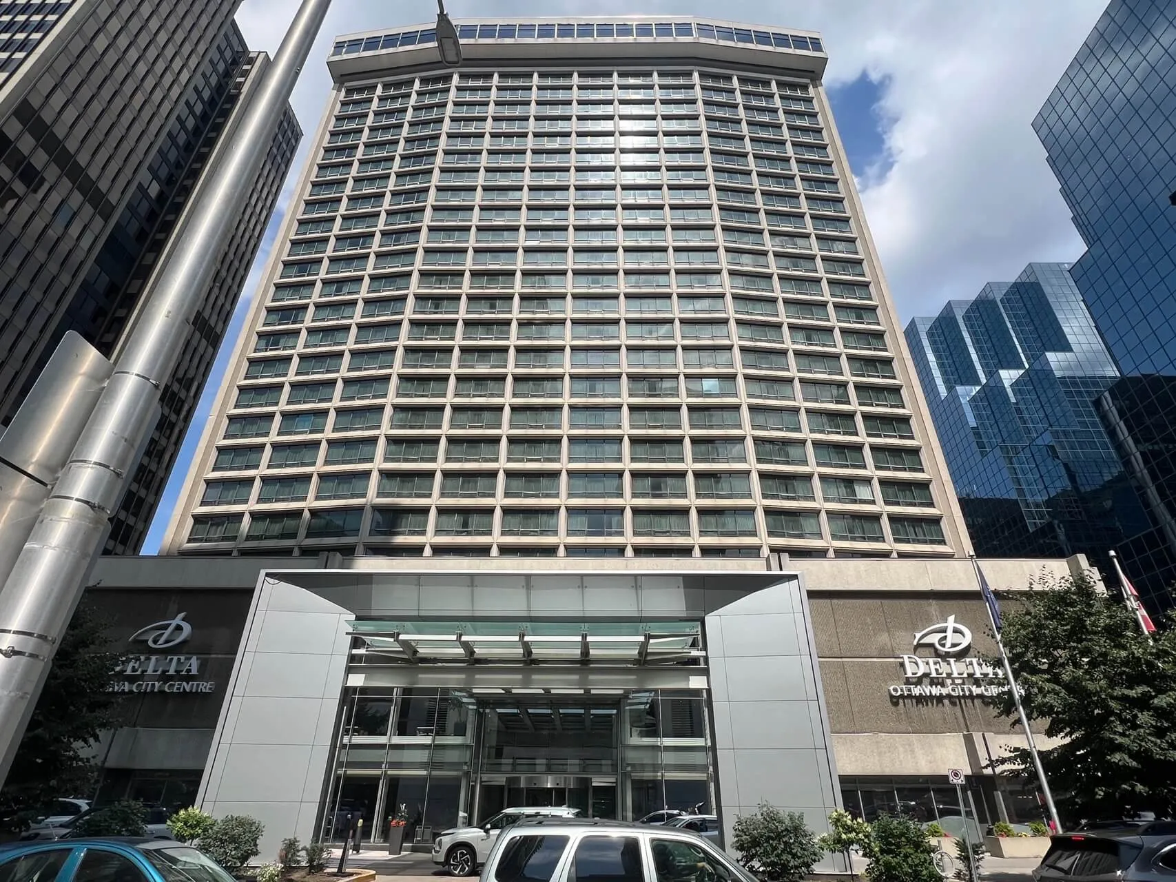 Delta Hotels by Marriott Ottawa City Centre entrance and façade, tall mid-rise hotel tower in downtown Ottawa.