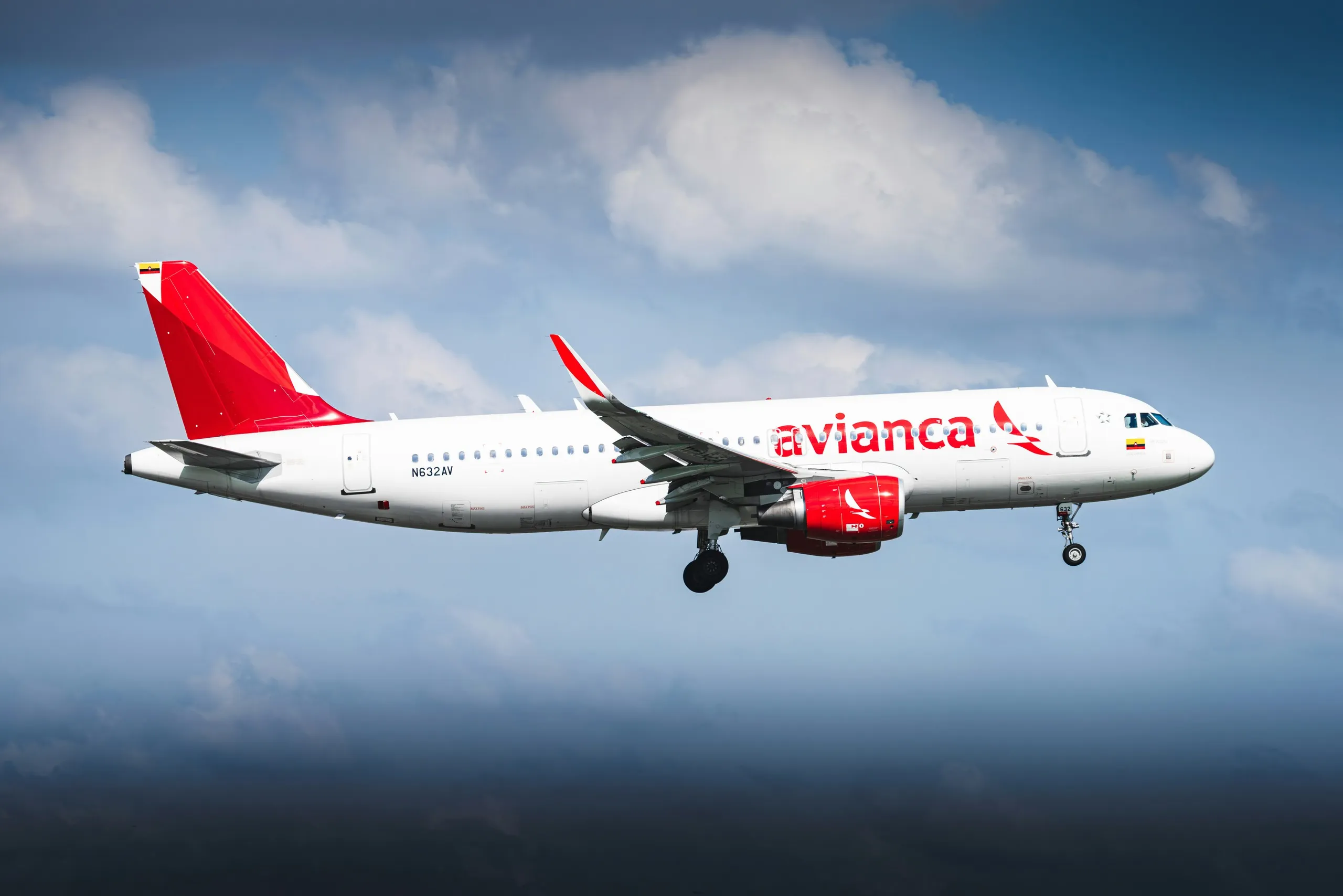 An Avianca Airbus A320 on approach under a cloudy sky