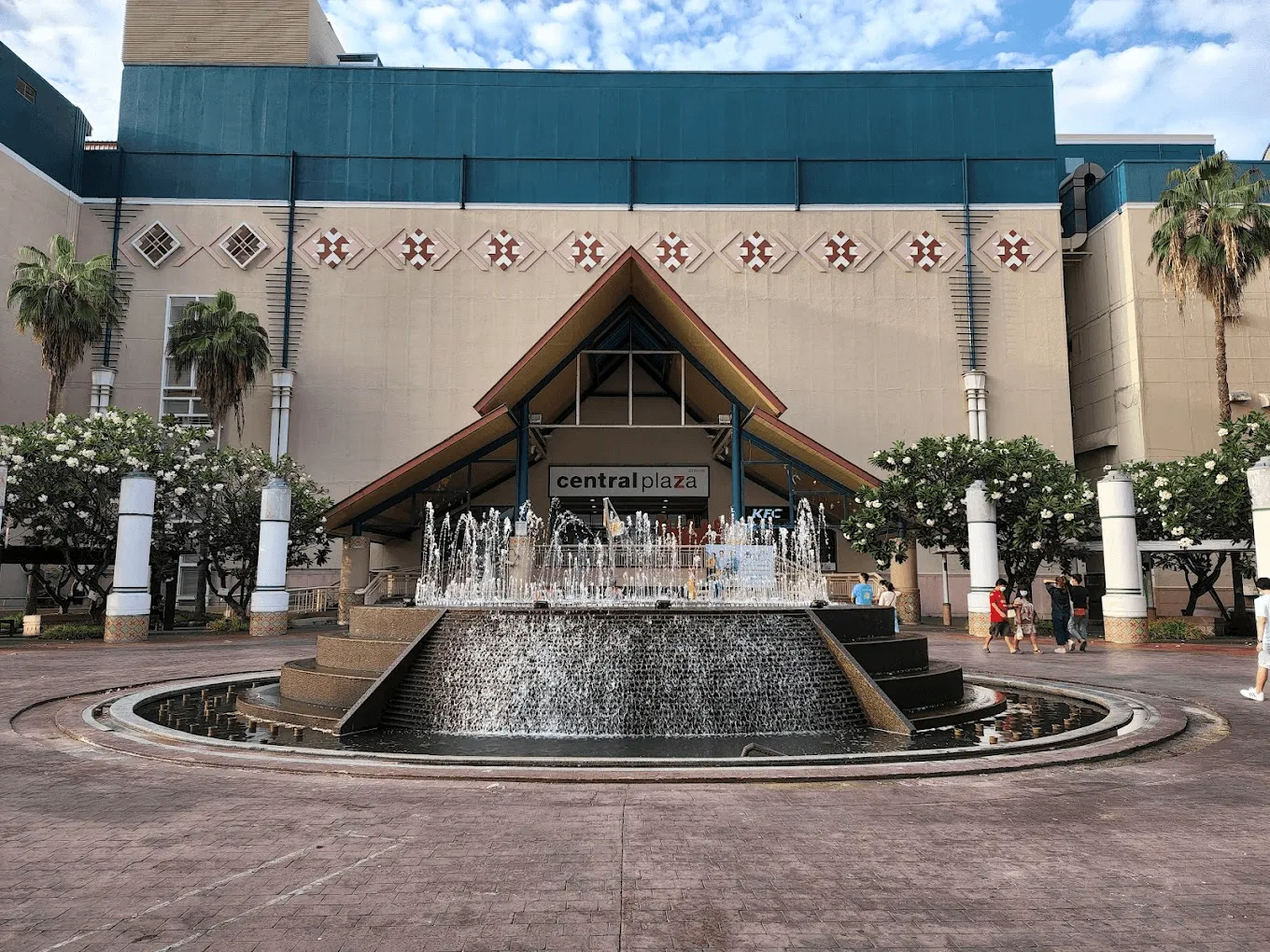 Central Plaza shopping mall exterior with central fountain and palm trees in Chiang Mai