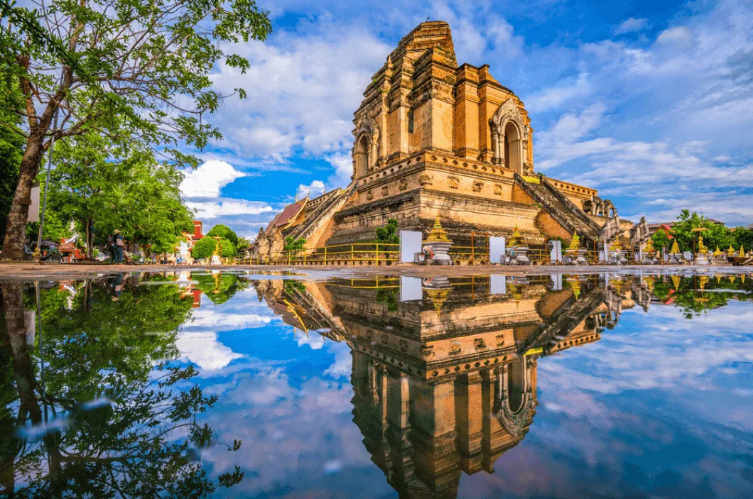 Wat Chedi Luang temple reflected in still water pool, Chiang Mai, Thailand