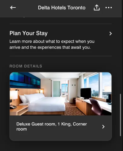 Deluxe guest room at Delta Hotels Toronto with king bed, corner window, city view, and work desk