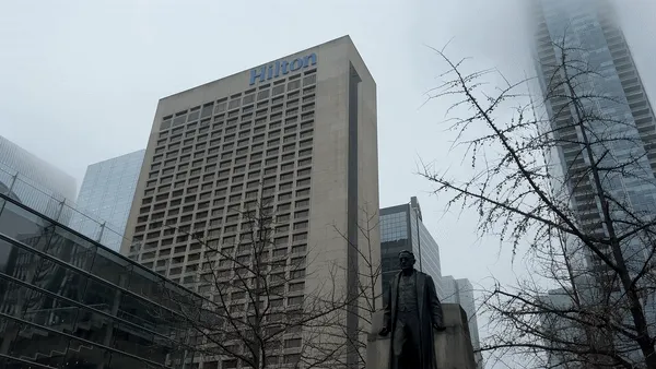 Hilton Toronto exterior, multi-story brutalist tower in downtown core with bare winter trees and overcast sky
