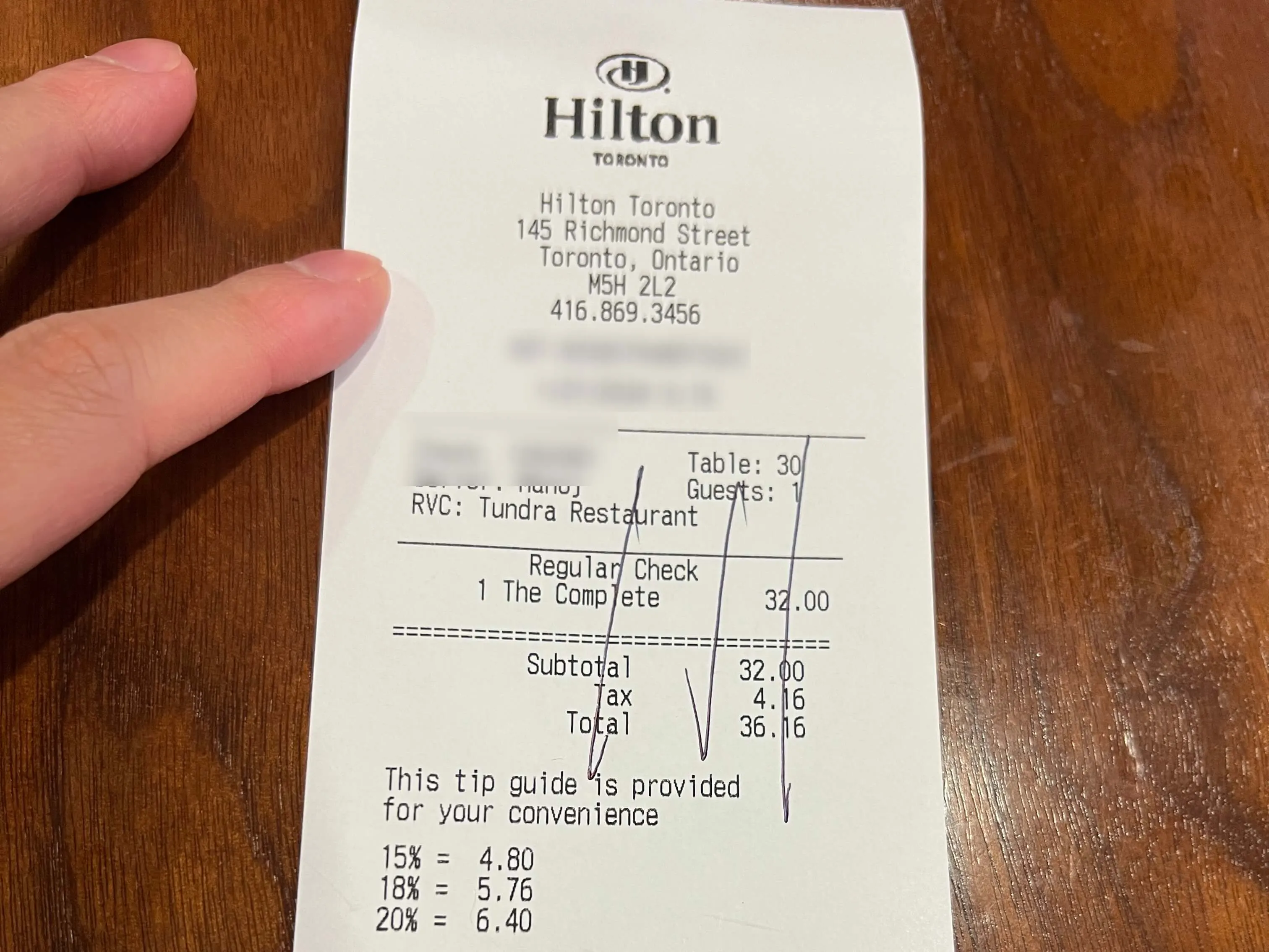 Hilton Toronto receipt from Tundra Restaurant showing breakfast charge of $32 with tax and tip guide.