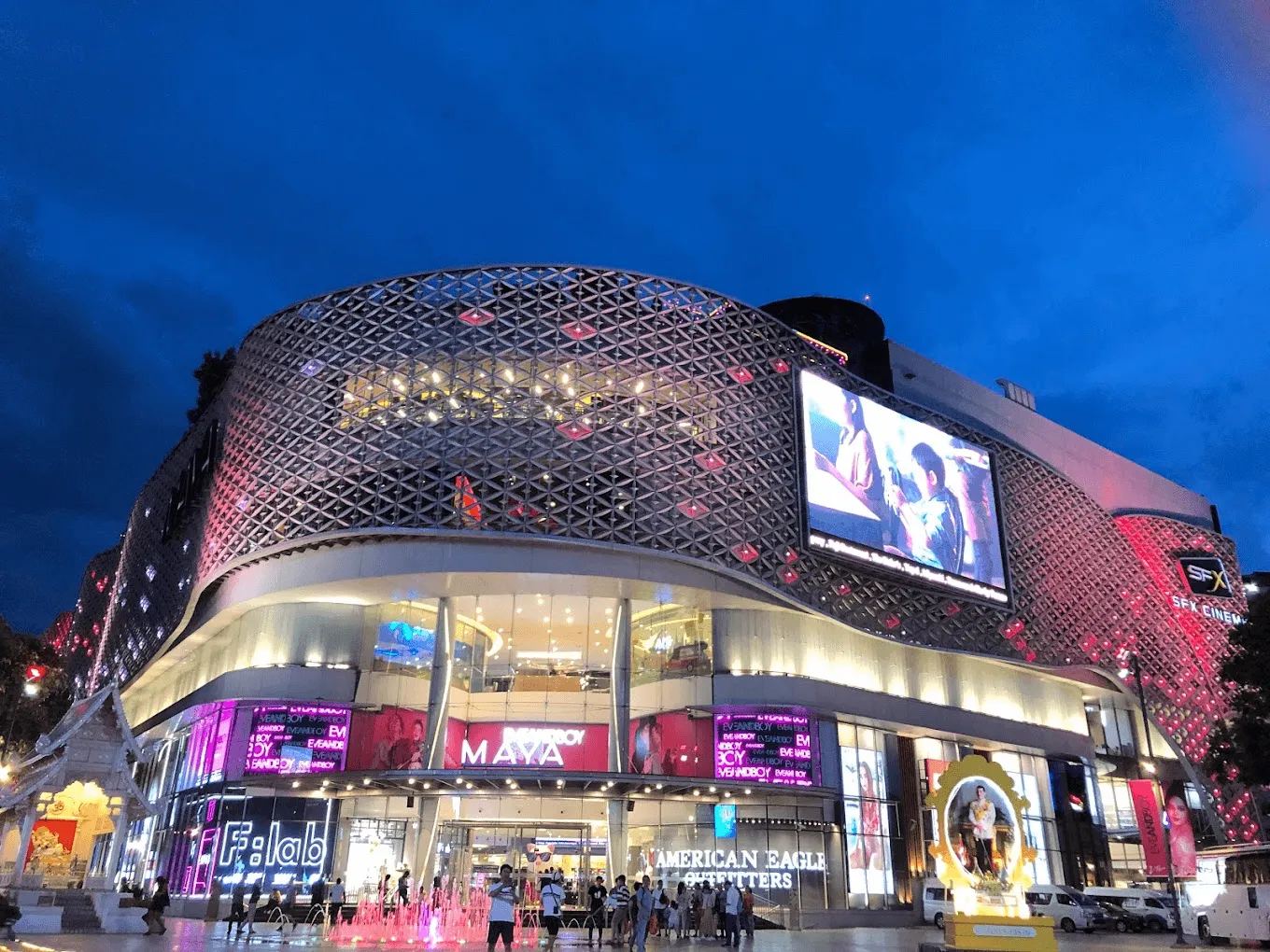 MBK Center (Maya) shopping mall exterior at night with illuminated mesh facade and pink lighting in Bangkok