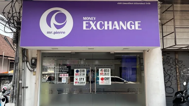 Mr. Pierre money exchange storefront with purple signage and currency rate displays for EUR, USD, JPY, CNY.
