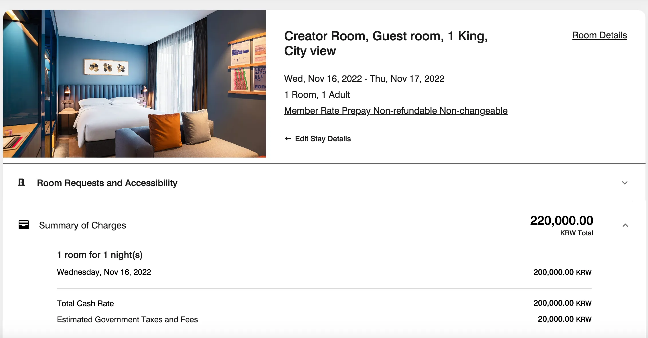 Creator Room with king bed, blue accent wall, city view, and orange throw pillows at Ryse Hotel