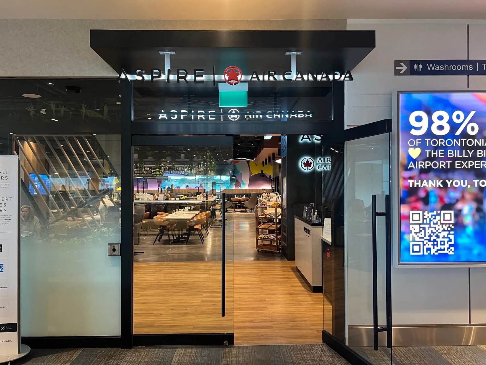 Aspire Air Canada lounge entrance at Toronto Pearson Airport with modern storefront design and illuminated signage